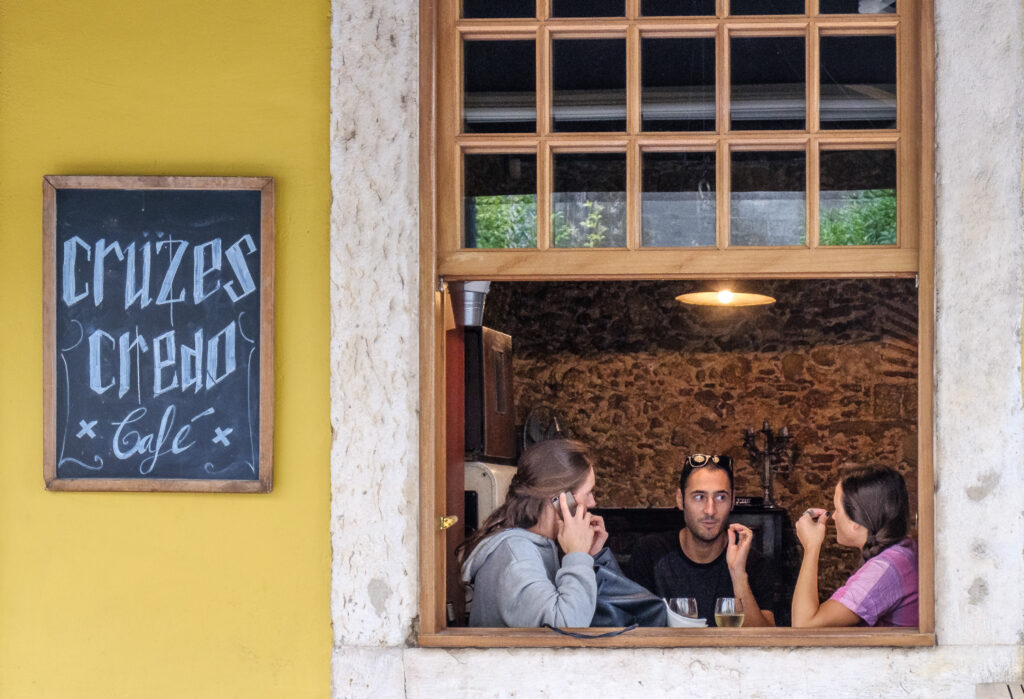 A cozy cafe in Lisbon brings friends together. 